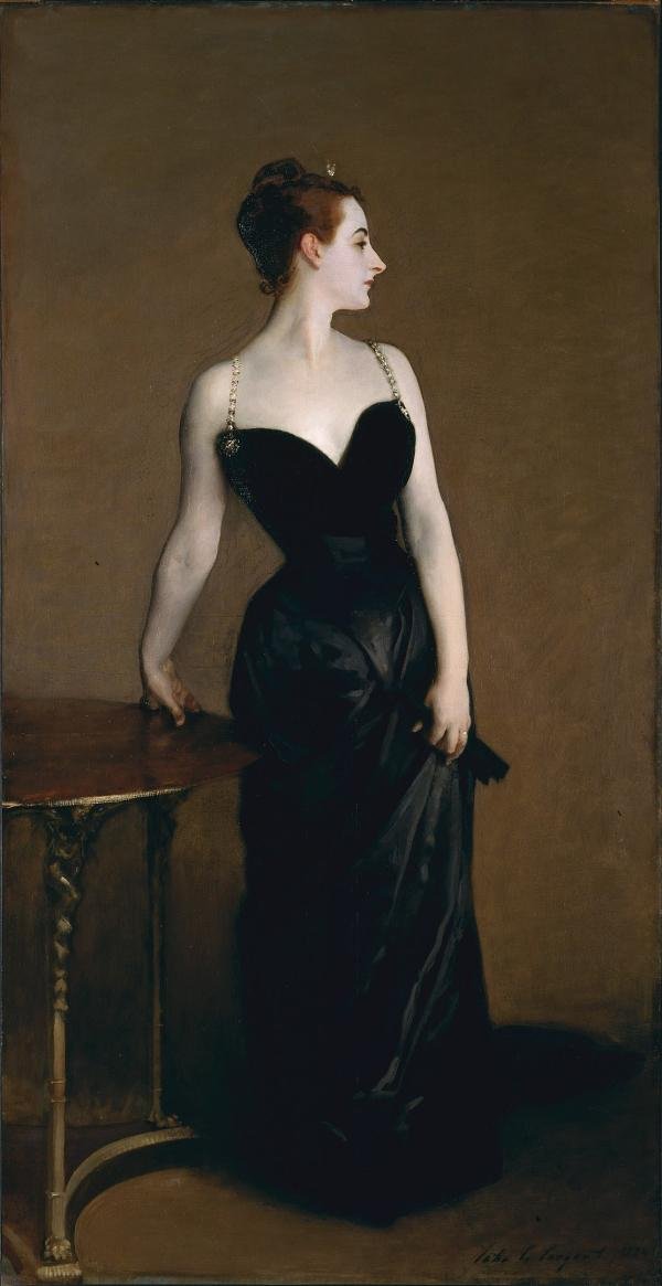 An elegant lady glances over her shoulder. Her dress is sleek, black and with thin straps