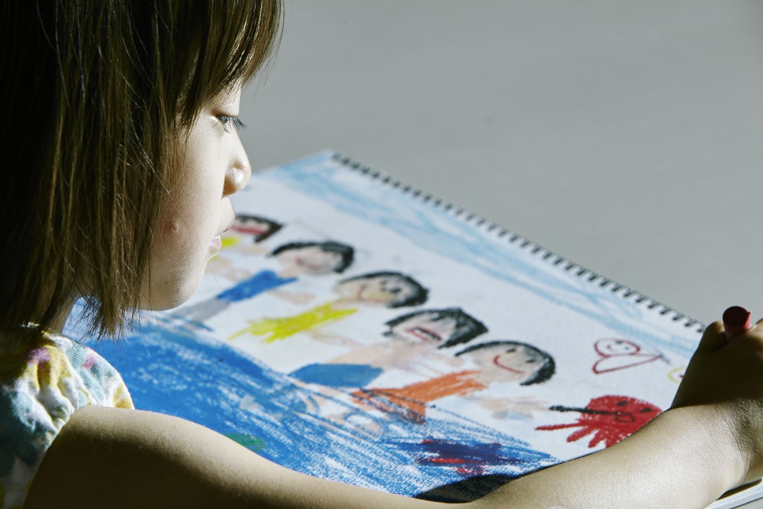 Film still: the little girl draws a picture of the Shibata family