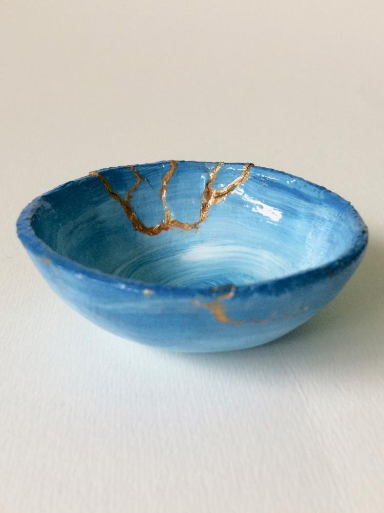 Kintsugi bowl: blue gradient bowl, with gold glue filling the cracks and breaks