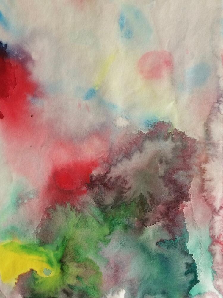 Various paints bleeding into each other on paper