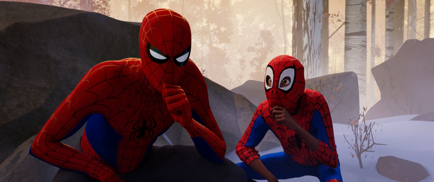 Film still: Peter B Parker ponders as he wears the spider-man outfit, Miles is shown behind copying him