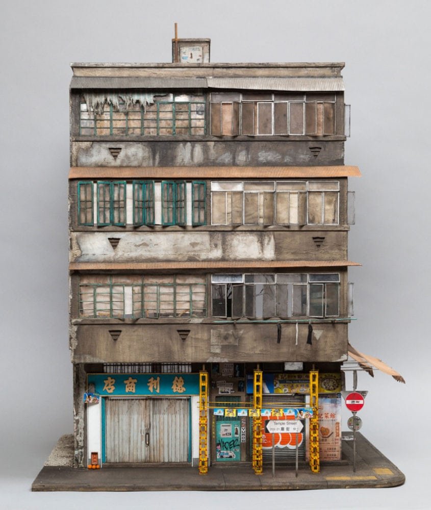 Miniature sculpture based on the building 23 Temple Street in Kowloon, Hong Kong. Shuttered shops make up the ground floor, while dilapidated flats line stacked above.