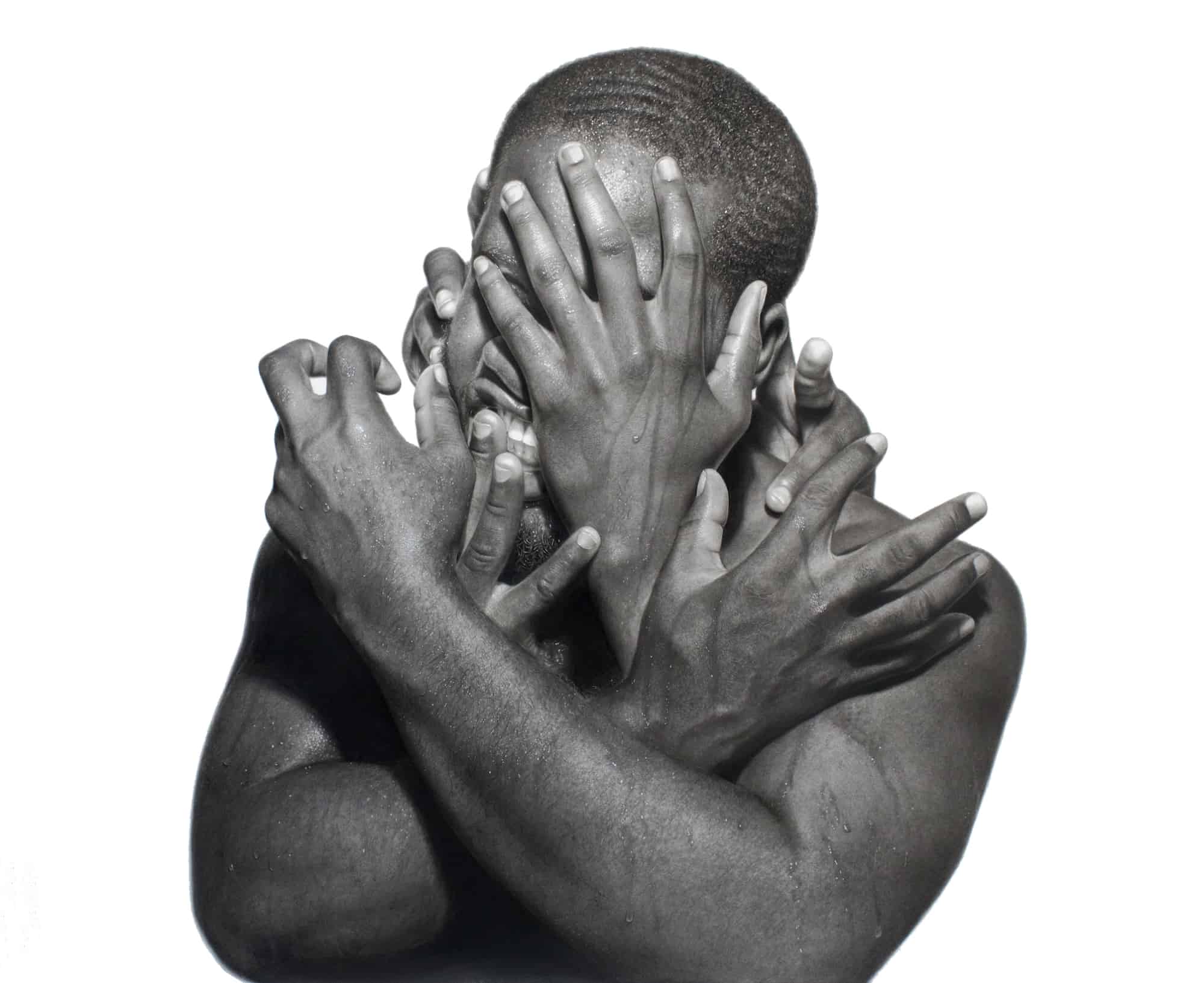 Hands pull and cover at a man's face