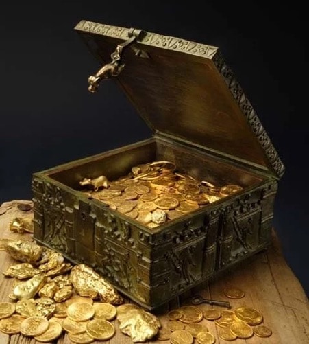 Photograph of an open treasure chest, with gold spilling out