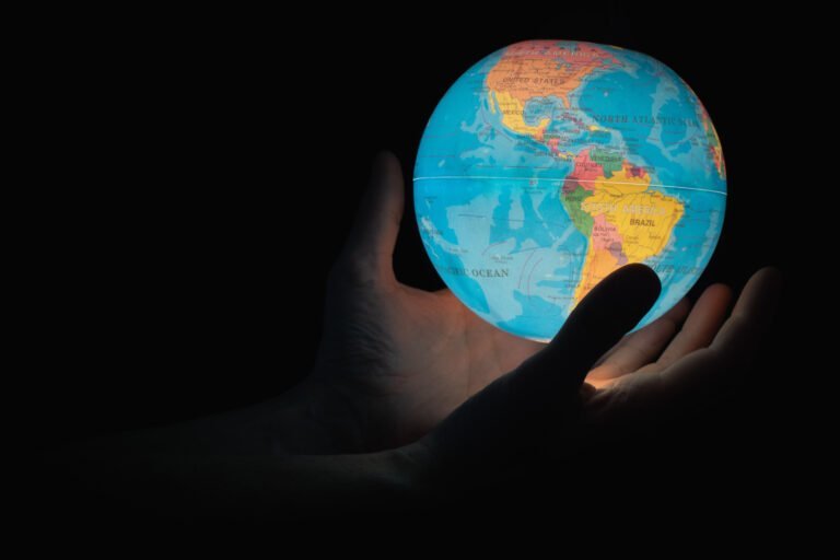 Photograph showing hands holding a globe