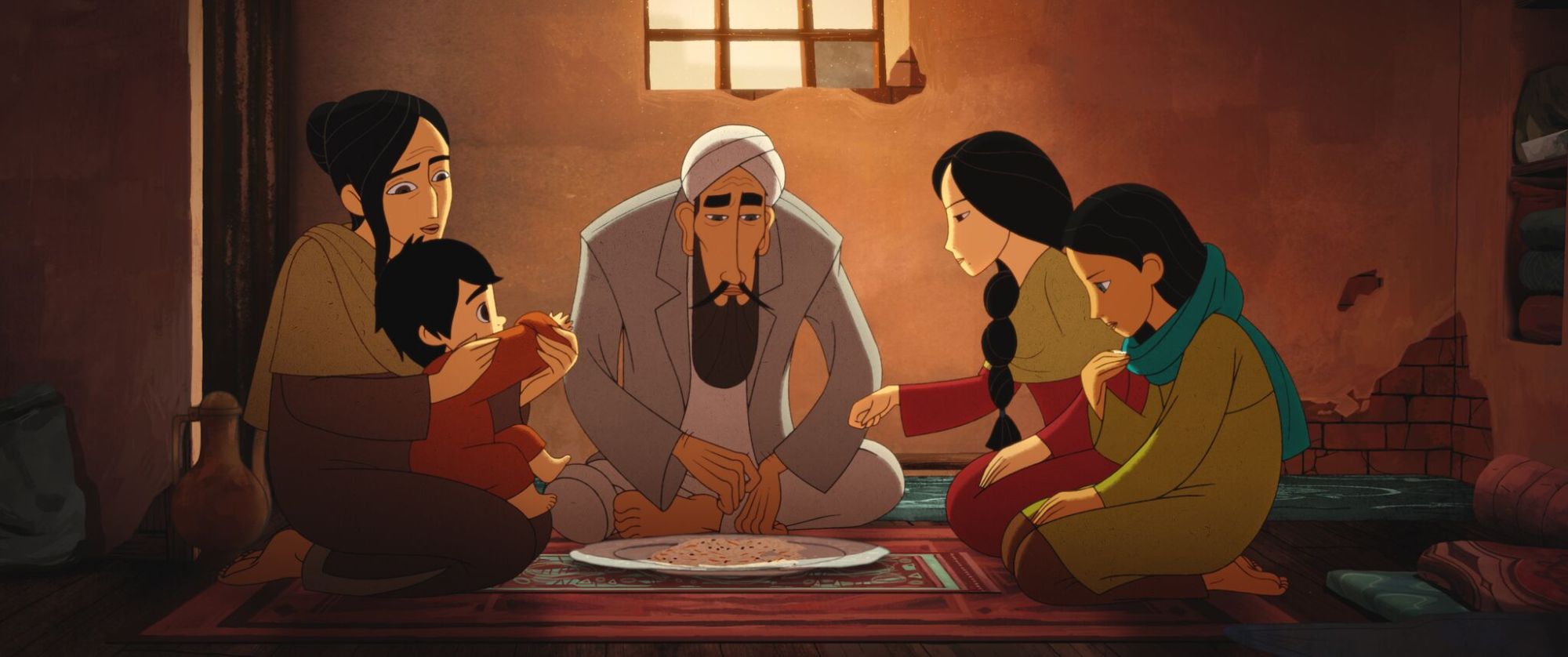 Film still: Showing Parvana and her family sit down for food