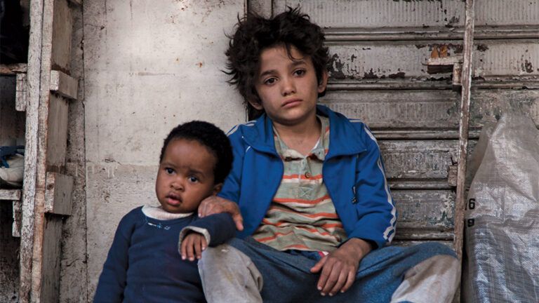 Still from the film showing a young boy, Zain, as he looks after an even younger boy, Yonas