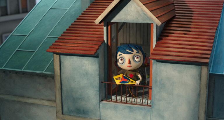 Film Still: Showing Courgette at the window of his bedroom attic, holding onto a kite