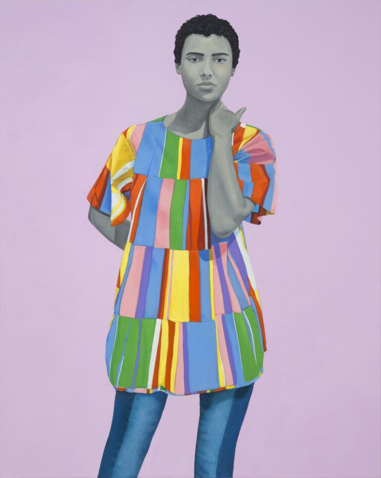 Portrait of a woman who looks strong and confident, one hand behind her back, the other on her neck. She's wearing a multicoloured top.