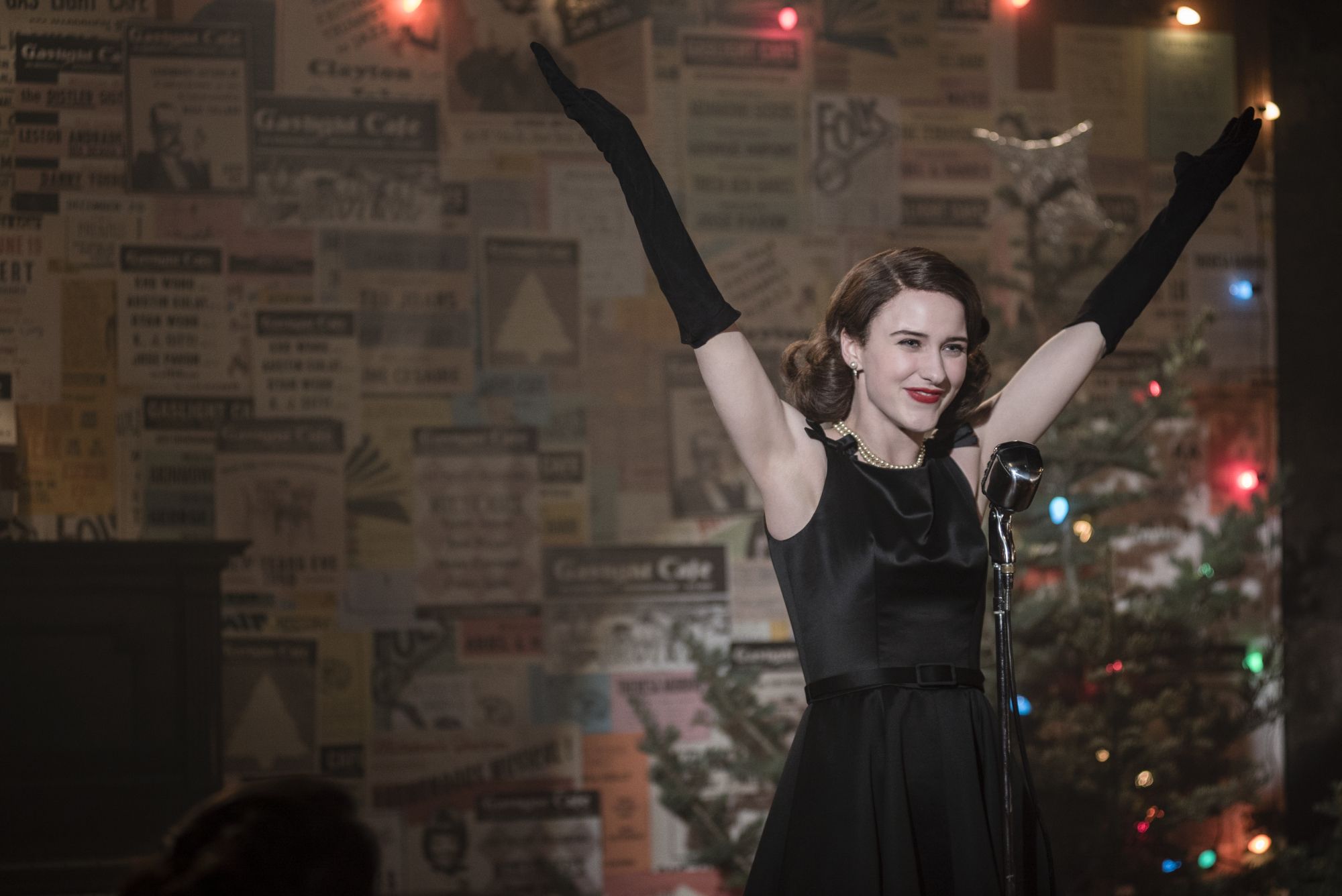 Film still: showing Mrs Maisel dressed up and embracing the success of her performance.