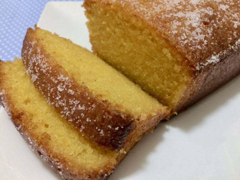 Photograph of a lemon drizzle cake cut into slices