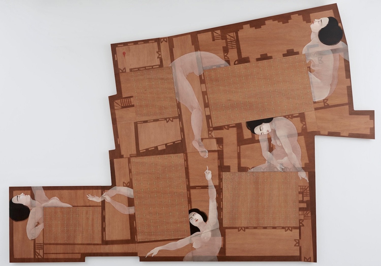 A wooden panel designed like the architectural plans of a house, wedged between the rooms are ghostly figures of women, some of which are incomplete