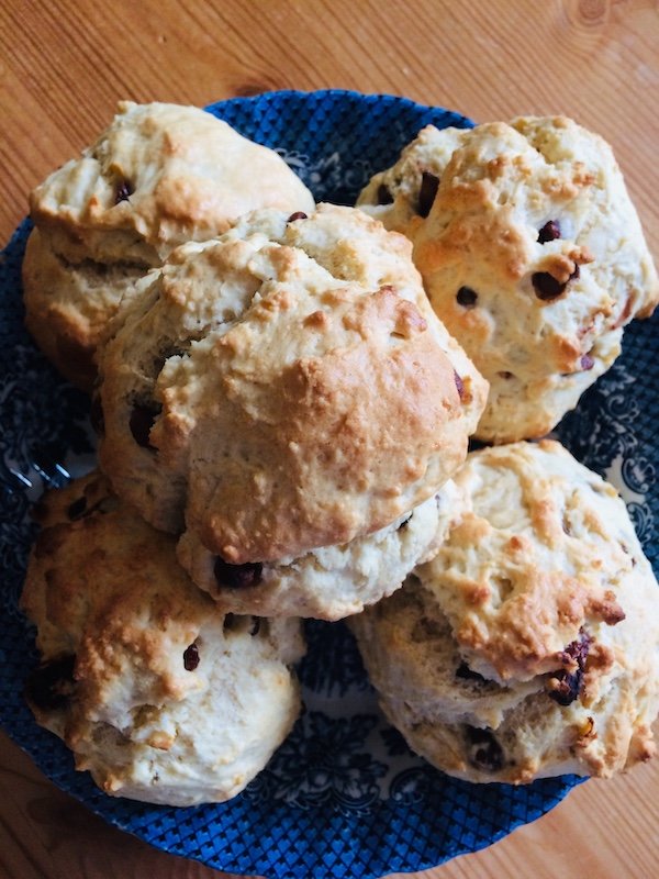 Photograph showing a fresh pile of scones in a large blue dish