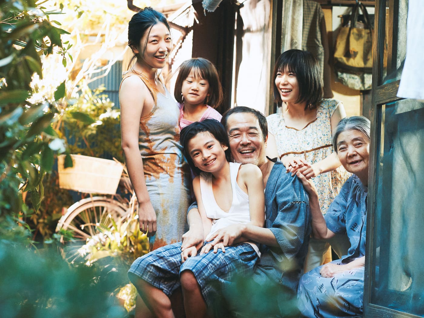 Photograph showing the Shibata family at home smiling